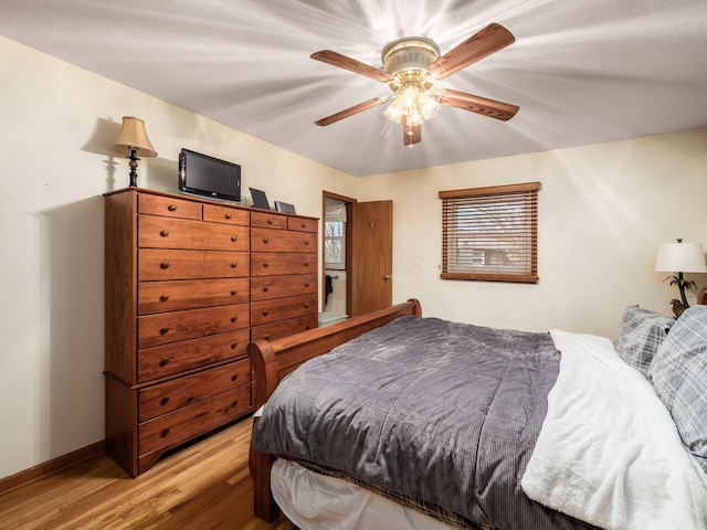 bedroom featuring ceiling fan and light wood-type flooring