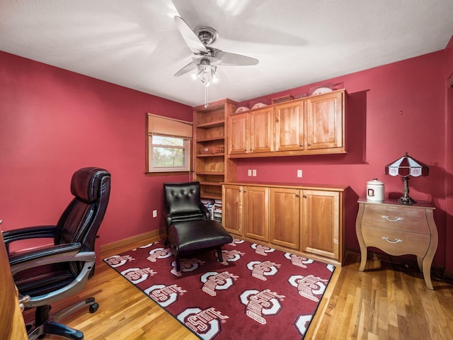 office area featuring hardwood / wood-style flooring, ceiling fan, and a textured ceiling