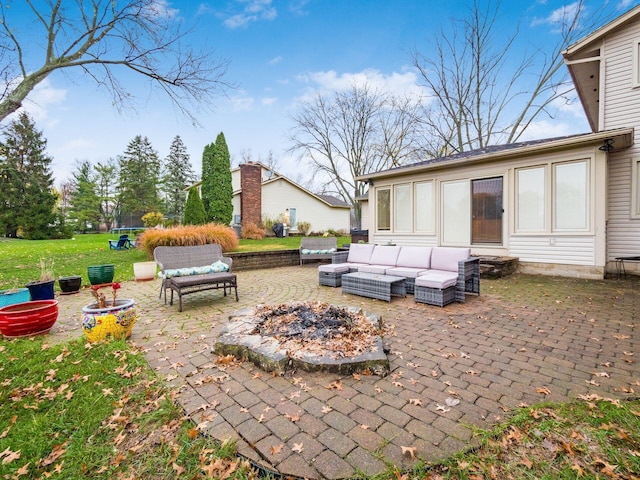 view of patio / terrace featuring an outdoor living space with a fire pit and a trampoline