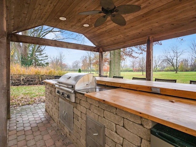 view of patio / terrace featuring a grill, ceiling fan, and exterior kitchen