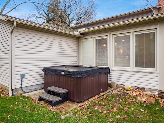 exterior space with a hot tub