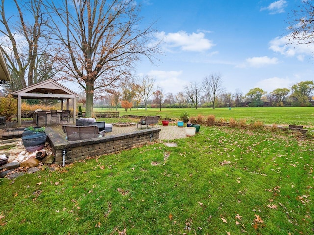 view of yard with a gazebo, exterior bar, and a rural view