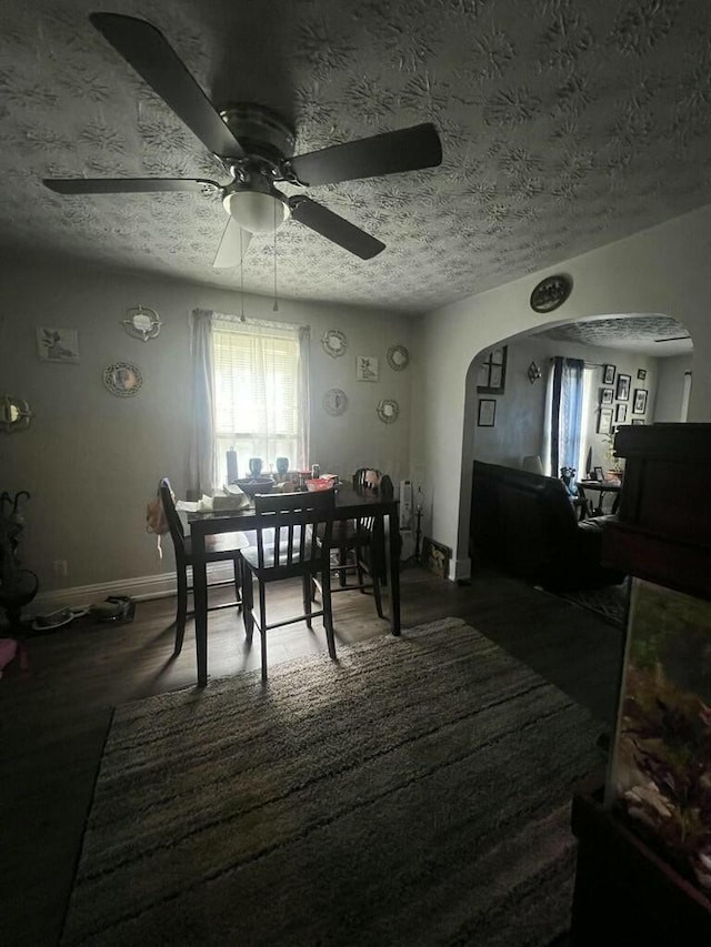 dining area featuring ceiling fan, dark hardwood / wood-style flooring, and a textured ceiling