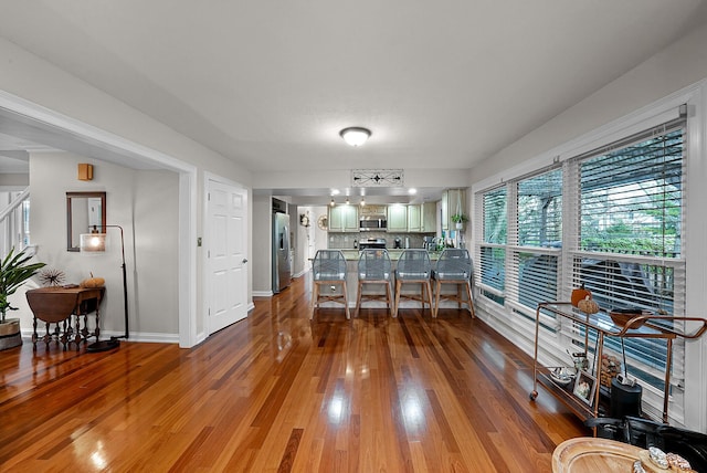 dining space with hardwood / wood-style floors