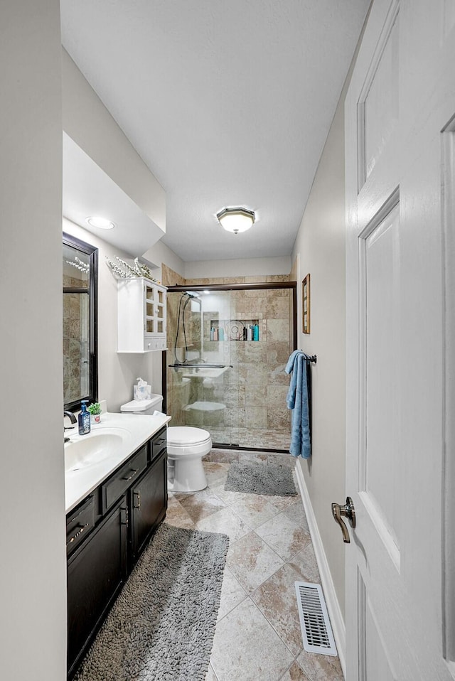 bathroom with vanity, toilet, and walk in shower