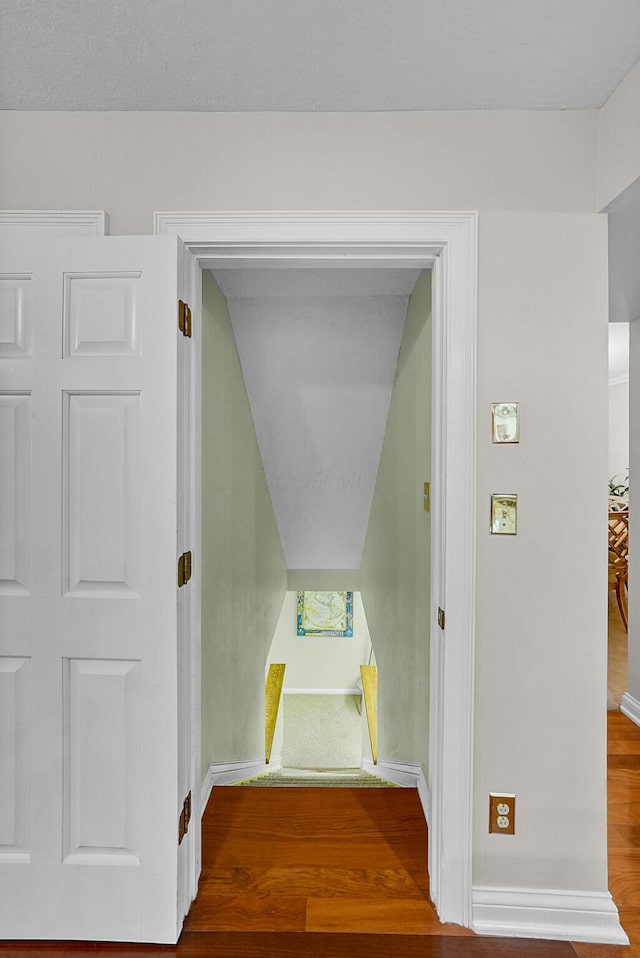 stairway with hardwood / wood-style floors