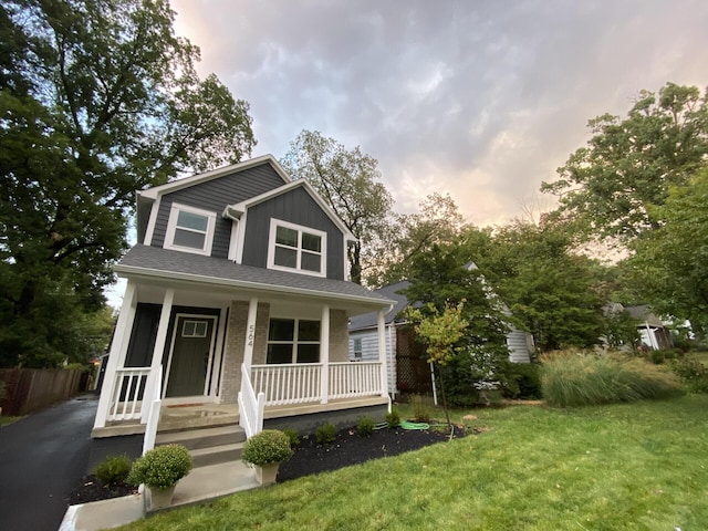 view of front facade with a porch and a yard