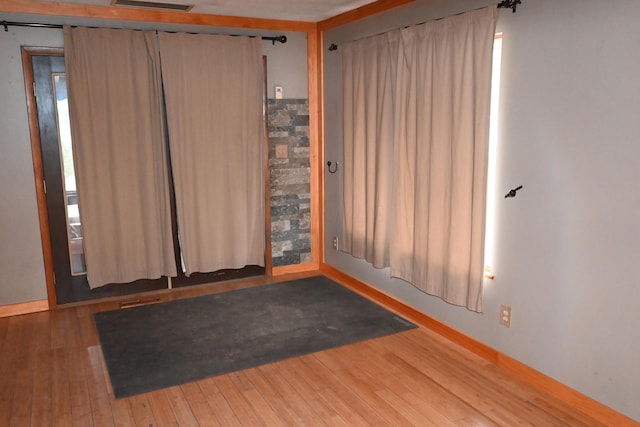 spare room featuring wood-type flooring