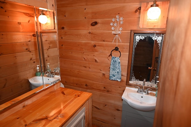 bathroom with vanity and wooden walls