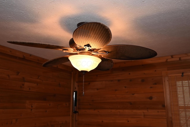 interior details with a textured ceiling and ceiling fan