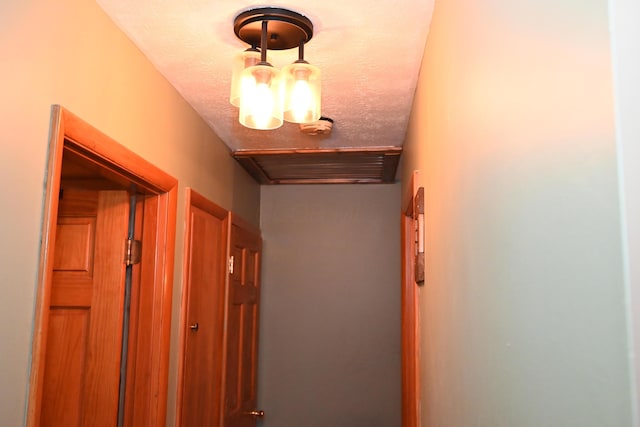 hallway with a textured ceiling