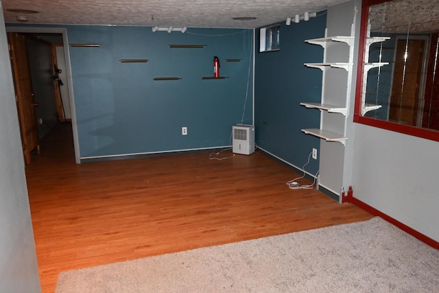 interior space featuring hardwood / wood-style floors and a textured ceiling