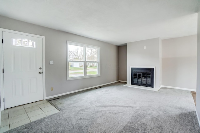 unfurnished living room featuring light carpet