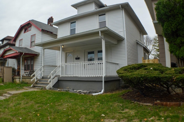 view of property featuring a porch and a front yard