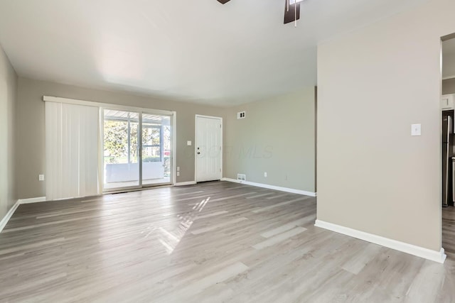 spare room with ceiling fan and light hardwood / wood-style floors