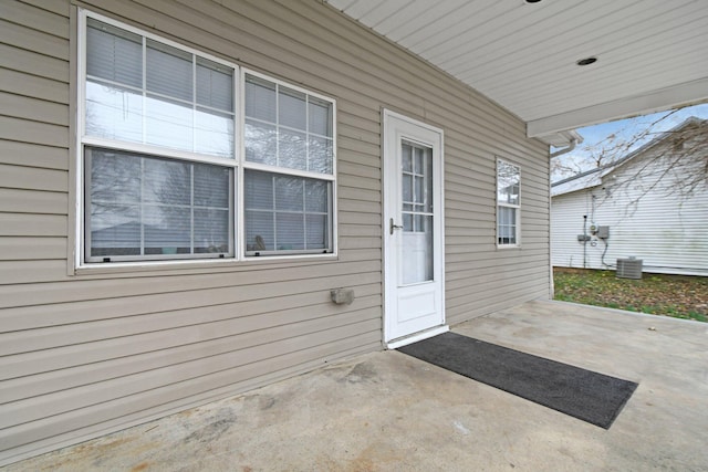 view of exterior entry with central AC unit