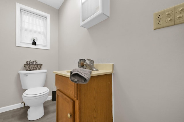 bathroom with vanity, hardwood / wood-style flooring, and toilet