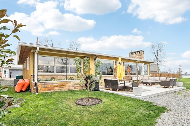 back of property with outdoor lounge area, central AC unit, a patio, and a lawn