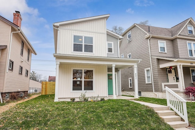 view of front of house with covered porch and a front lawn