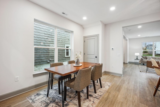 dining space with light hardwood / wood-style flooring