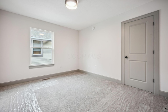 spare room featuring carpet flooring