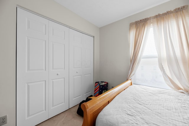 carpeted bedroom with a closet