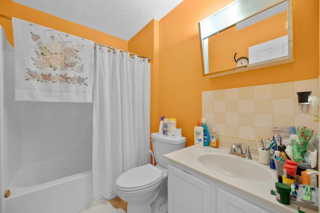 full bathroom featuring vanity, a textured ceiling, toilet, and shower / bath combo with shower curtain