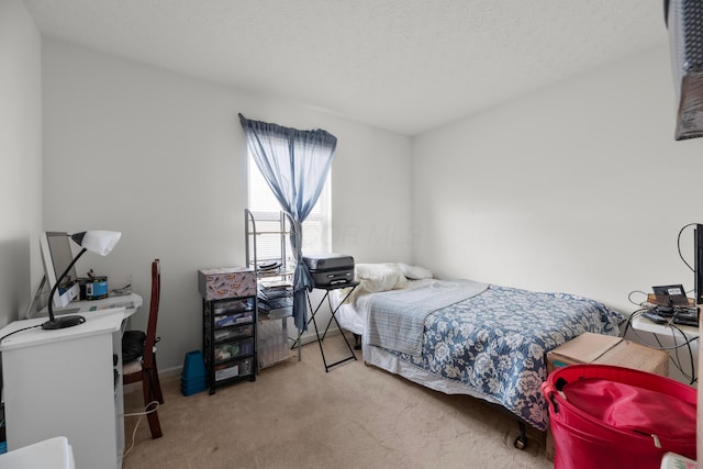 bedroom featuring carpet flooring and a textured ceiling