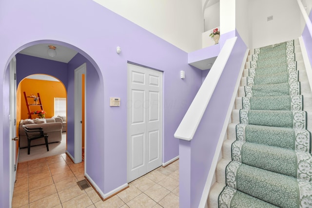 stairs featuring tile patterned flooring