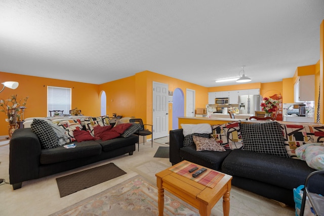 living room featuring light colored carpet and a textured ceiling