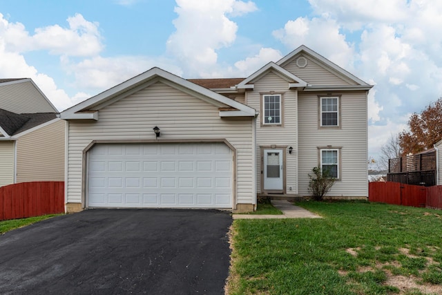 view of front of house featuring a garage and a front lawn