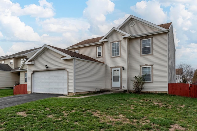 view of property featuring a front yard and a garage