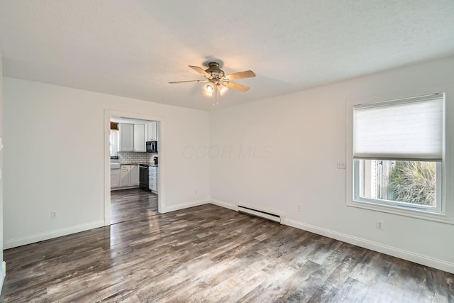 unfurnished room featuring a textured ceiling, dark hardwood / wood-style flooring, ceiling fan, and a baseboard heating unit