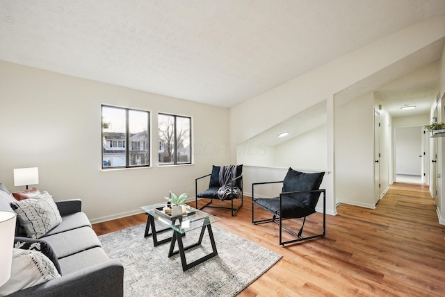 living room with hardwood / wood-style floors and a textured ceiling