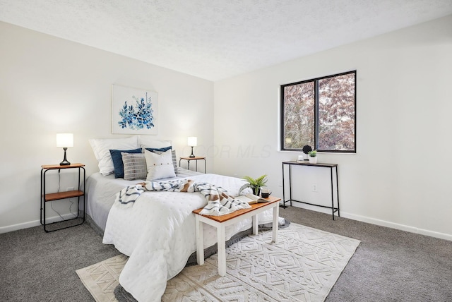 bedroom with carpet and a textured ceiling