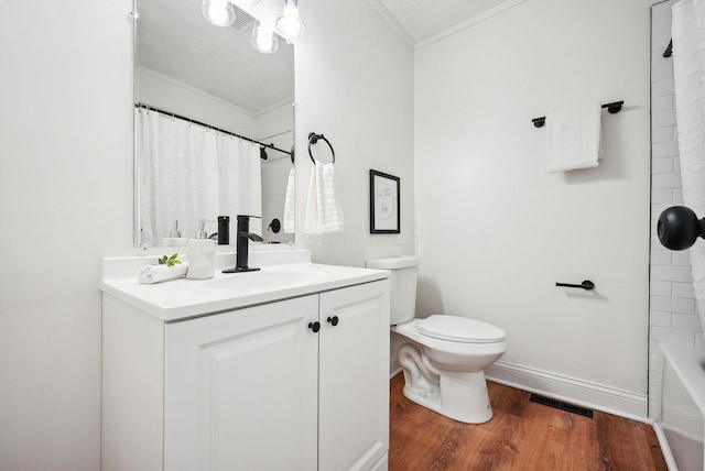 full bathroom featuring vanity, shower / bath combo with shower curtain, crown molding, hardwood / wood-style floors, and toilet