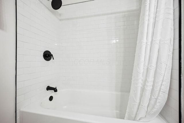 bathroom featuring shower / tub combo with curtain