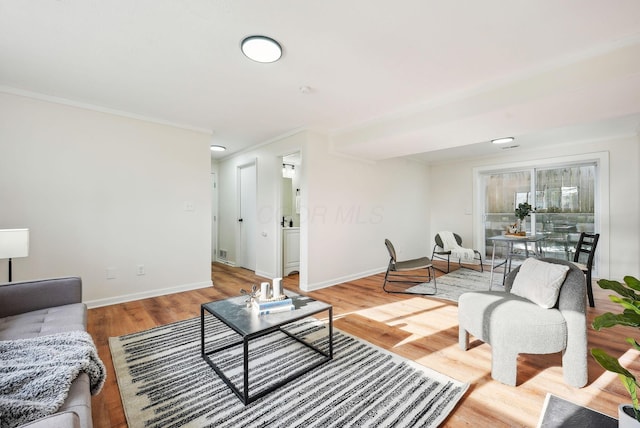 living room with ornamental molding and hardwood / wood-style flooring