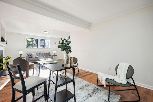 dining room featuring hardwood / wood-style floors and ornamental molding