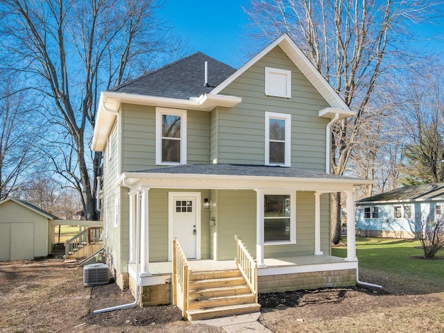 front of property featuring central AC and a shed