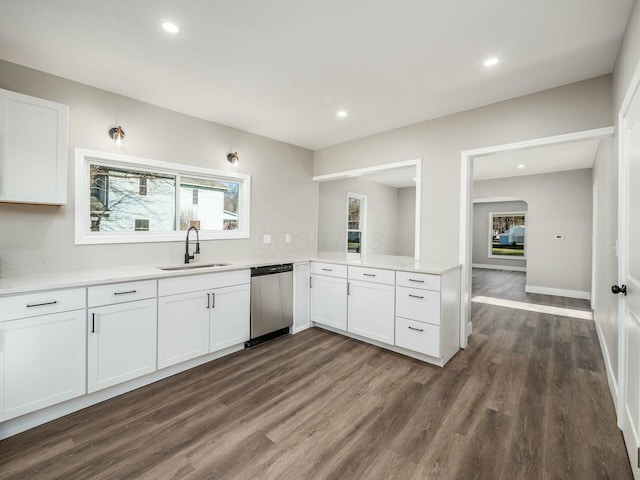 kitchen featuring stainless steel dishwasher, white cabinetry, and sink