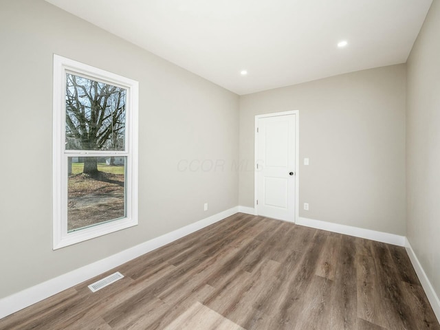 unfurnished room with wood-type flooring