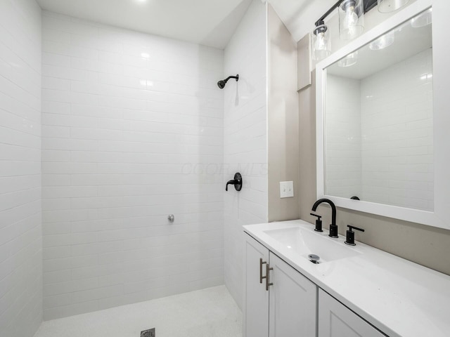 bathroom with vanity and tiled shower