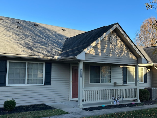 view of front of home with covered porch and central AC