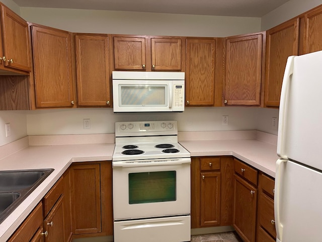 kitchen with white appliances and sink