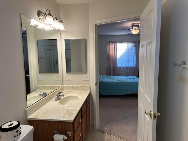 bathroom with ceiling fan, toilet, and vanity