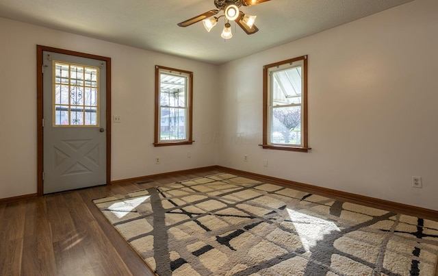 entryway with ceiling fan, a healthy amount of sunlight, a textured ceiling, and hardwood / wood-style flooring