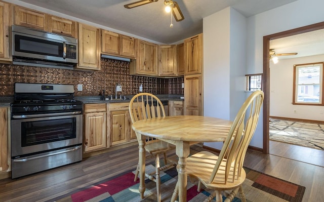 kitchen featuring backsplash, a textured ceiling, dark hardwood / wood-style floors, and appliances with stainless steel finishes