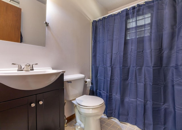 bathroom with vanity, toilet, and walk in shower