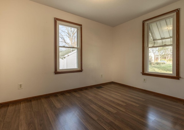 empty room featuring dark wood-type flooring